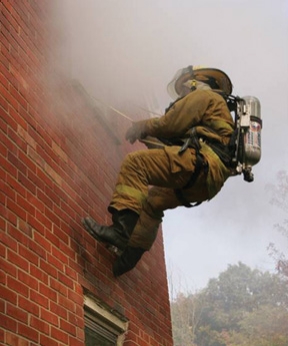 A firefighter uses a RIT Rescue Systems Class II harness and PRESS system to bail out of a building