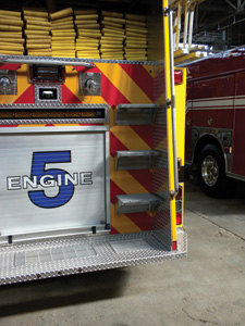 (6) The rear of this apparatus incorporates a rear tailboard, access steps larger than the NFPA's minimum requirement, and handrails that appear to make access and egress user-friendly.