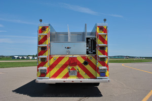 (9) Both sides at the rear of this CustomFIRE pumper for the St. Paul (MN) Fire Department have full height handrails on each side of custom width access steps to facilitate climbing while meeting the three-points-of- contact concept. Just visible on the compartment tops are the ends of two additional grab rails.