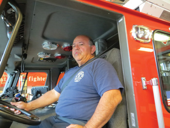 (3) NFPA 1901 is not retroactive. Many first line apparatus still have black seatbelts. Firefighters who wear black or blue uniforms or black turnout coats may confuse the seat belt with SCBA straps. Black on black also makes it hard for the driver and officer to see if crew members are buckled in. In this photo, the driver is buckled in, but it's hard to tell.