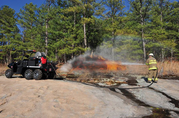 (5) A firefighter uses an HMA Fire UHP on a UTV to fight a wildland fire.