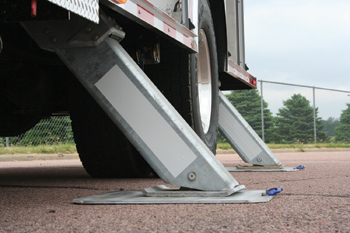 A-frame outriggers are on a Rosenbauer pumper fitted with an extended aluminum boom that functions as an elevated water supply delivery device