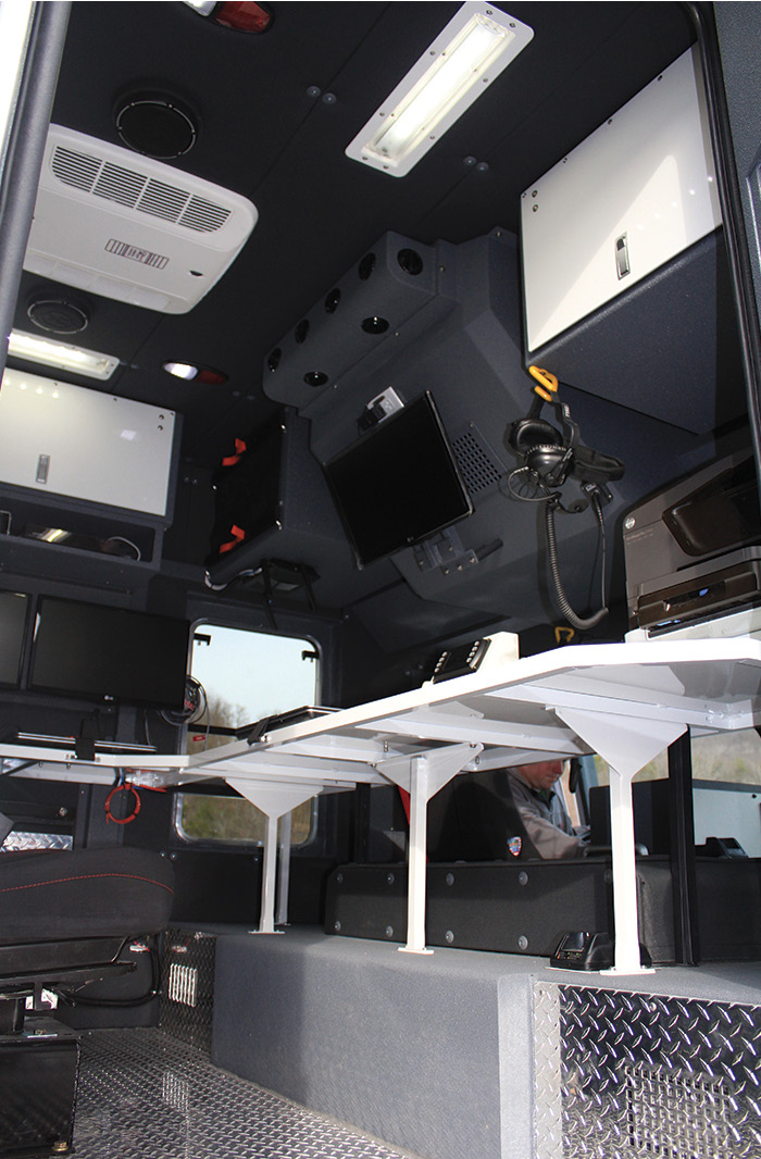 The interior command area on the Philadelphia CBRNE hazmat truck can monitor cameras, infrared sensors, a weather station, and satellite connection on two telescoping masts at the rear of the vehicle.