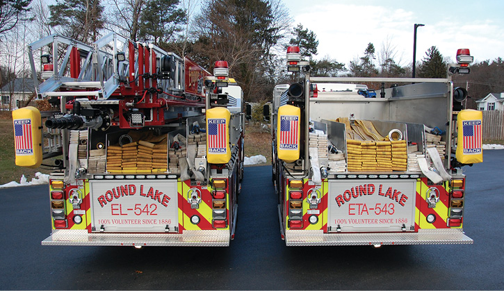 The rear of both Round Lake Sutphen apparatus with low hosebeds and multiple attack line storage