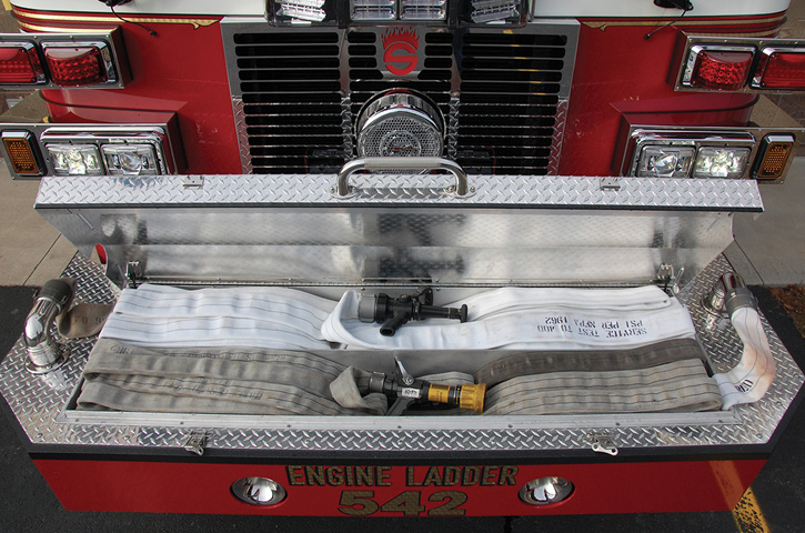 The front bumper design of the apparatus features two discharges to allow deployment of two lines off the front of the rig.