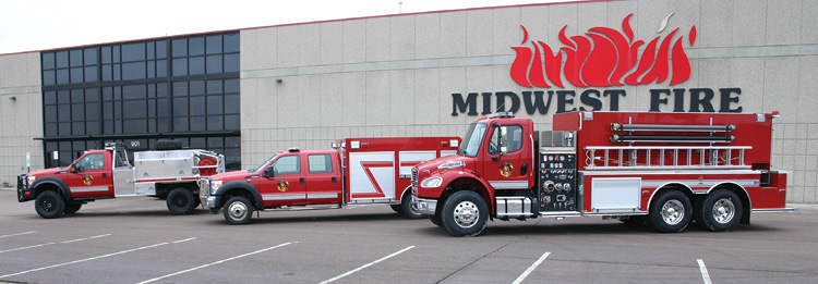 This line-up in front of Midwest’s factory shows another variation of a brush truck with a treadplate body, a small rescue truck, and a large-capacity tanker-pumper on a two-door commercial chassis with a tandem rear axle.