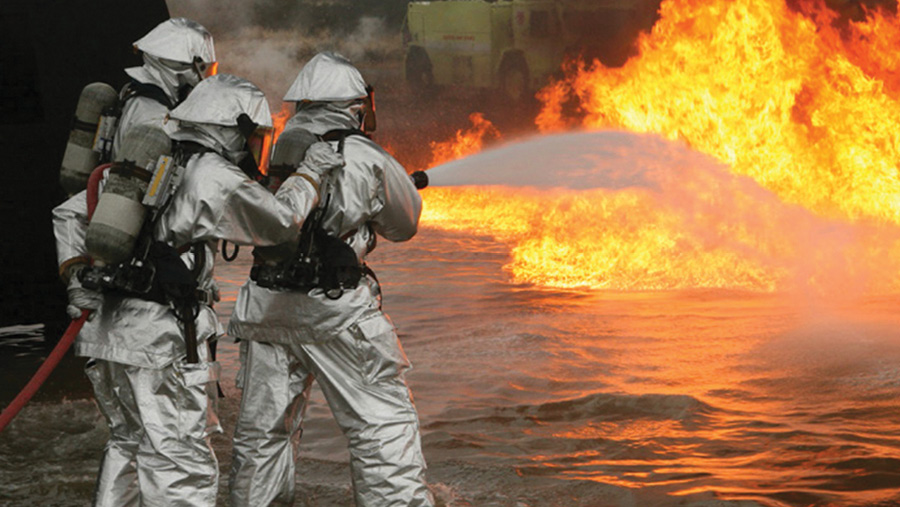 Firefighters outfitted in INNOTEX proximity gear tackle a flammable liquid fire.