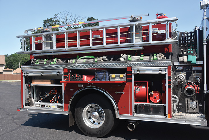 The officer’s side Holmatro combi tool, fans, high-rise hose packs, electric reels, and assorted tools.