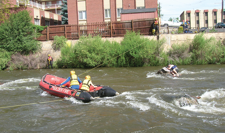 Firefighters use a tethered inflatable boat to reach a victim stranded in swift water. (Photos 1-2 courtesy of Dive Rescue International.)