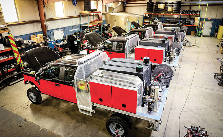 An inside view of the “wildland” fabrication shop showing the four rigs in photo 4 under construction.