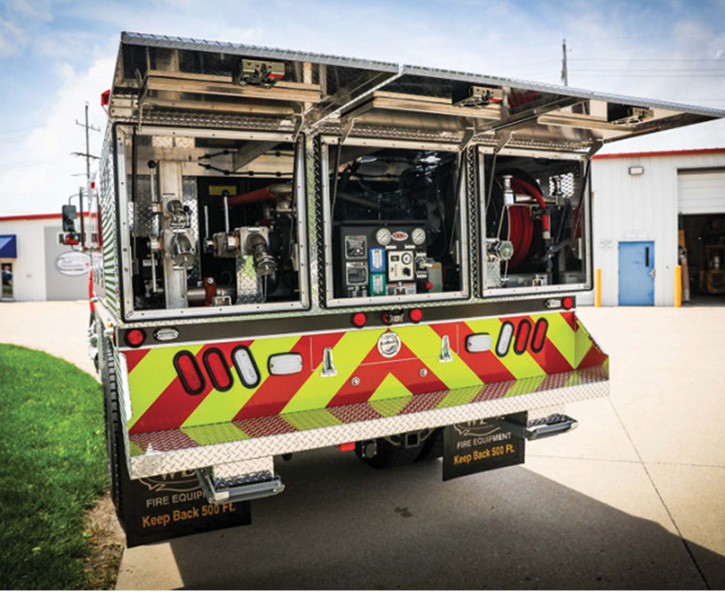 A rear view of the Stanley tanker shows the pump, hose connections, controls, and booster reel protected behind three lift-up doors. 