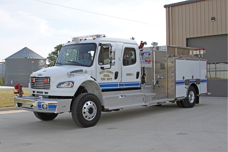 Weis Fire and Safety delivered this Toyne 1,250-gpm 1,250-gallon pumper-tanker to the Scott City (KS) Rural Fire Department on a four-door Freightliner. It features high left- and low right-side compartments, top-mount pump controls, a booster reel in the rear step compartment, an 8-kW hydraulic generator, and an extended front bumper with a monitor and a discharge for a preconnect. (Photo courtesy of Toyne.) 