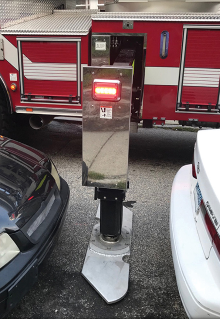 A Pierce aerial H-style jack sets up between two parked cars.