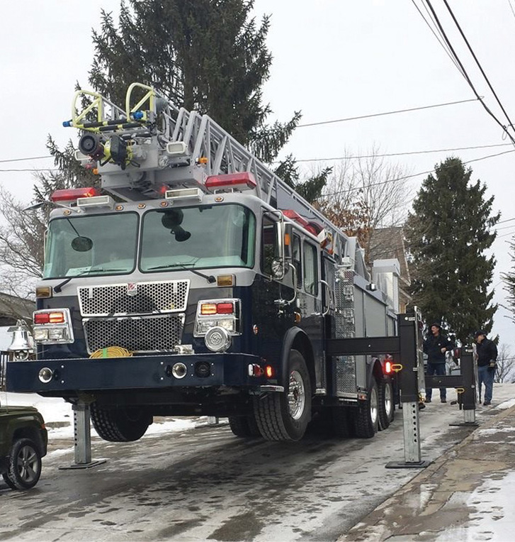 The Smeal 105-foot aerial ladder has four H-style outriggers that spread to 16 feet, two behind the cab and two behind the rear axle.