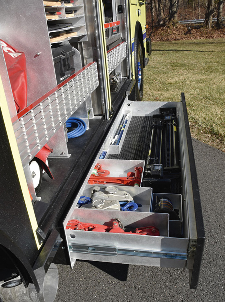 A roll-out under-body compartment with rigging equipment.