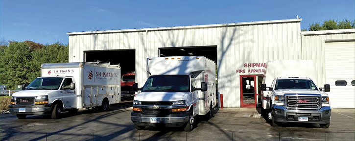 A few of its 14 road service trucks in front of apparatus service bays. 