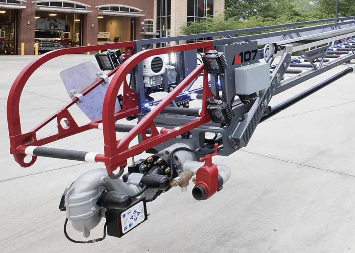 Equipment on the tip of this Pierce Ascendant 107-foot aerial ladder includes four LED lighting units, ladder tip controls, and a chain saw scabbard.